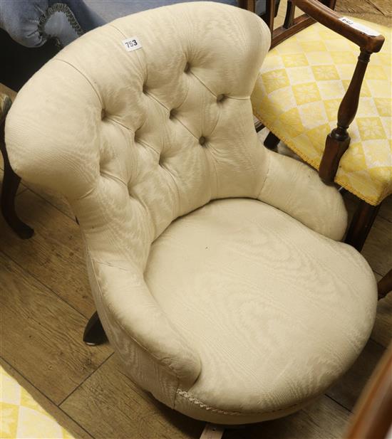 A Victorian button-back sewing chair, upholstered in ivory fabric, on turned legs